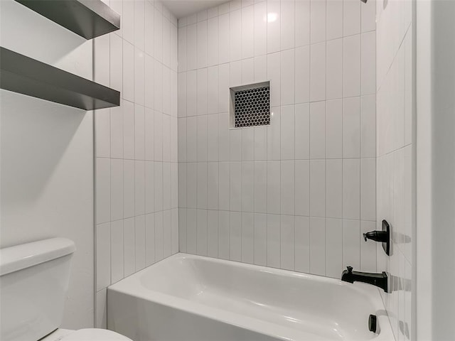 bathroom featuring shower / bathing tub combination and toilet