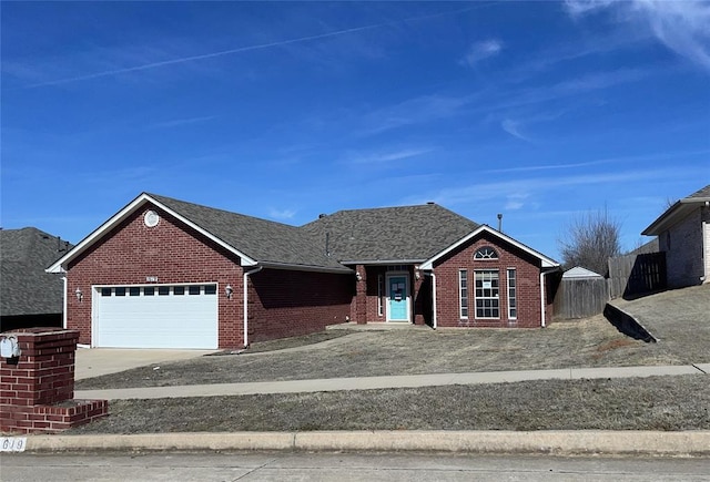 single story home with brick siding, an attached garage, concrete driveway, and roof with shingles