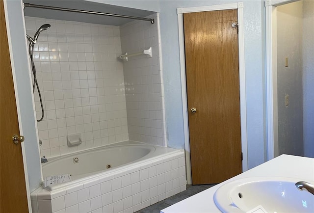 bathroom with tub / shower combination and a sink