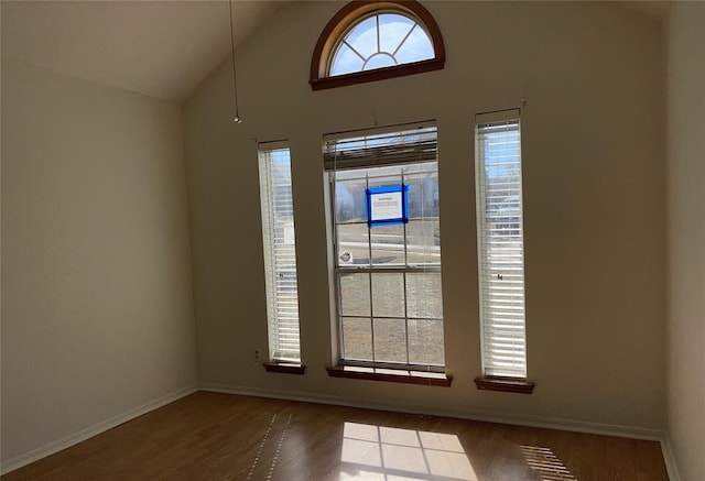 interior space with baseboards and wood finished floors