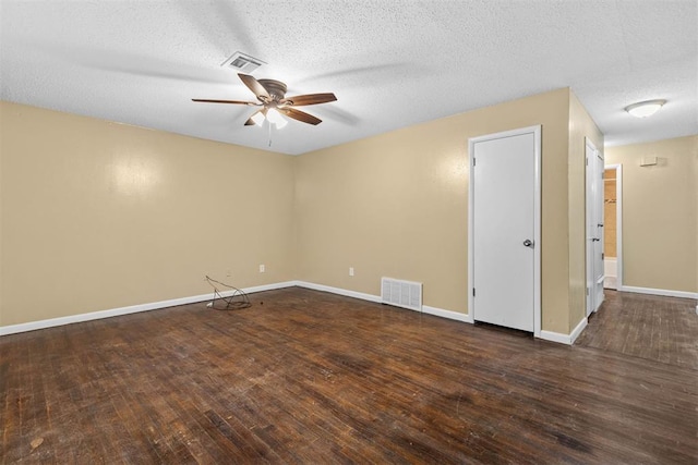 empty room with visible vents, baseboards, ceiling fan, and hardwood / wood-style flooring