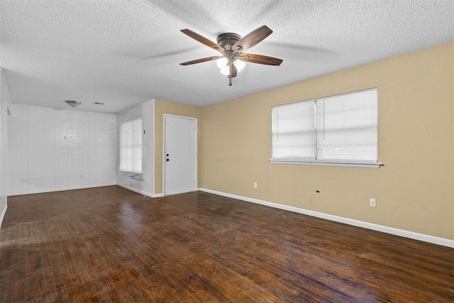 unfurnished room with baseboards, a textured ceiling, a ceiling fan, and wood-type flooring