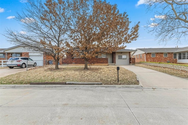 ranch-style house featuring brick siding and driveway