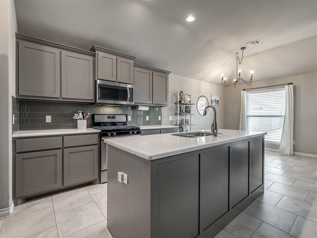 kitchen with a sink, visible vents, gray cabinets, and stainless steel appliances