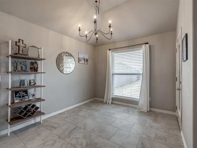 unfurnished dining area featuring baseboards, a notable chandelier, and vaulted ceiling