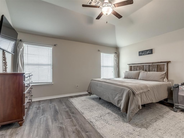 bedroom with a ceiling fan, lofted ceiling, dark wood-style floors, and baseboards