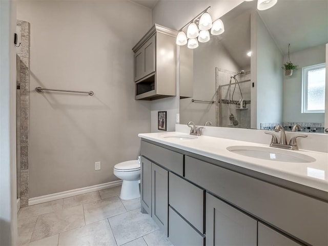 bathroom with a tile shower, tile patterned flooring, toilet, and a sink