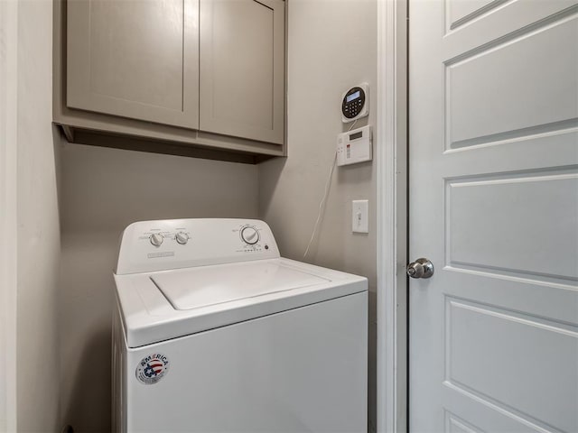 washroom with cabinet space and washer / clothes dryer