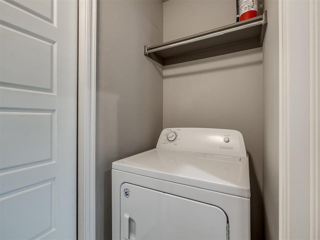 clothes washing area featuring laundry area and washer / clothes dryer