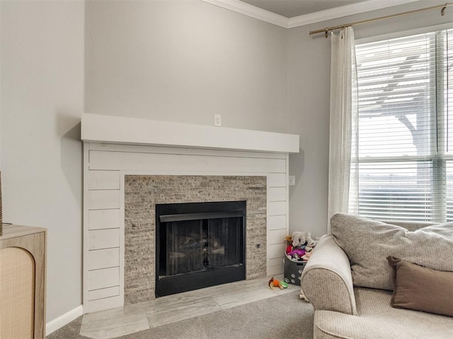 living area featuring baseboards, carpet floors, ornamental molding, and a tile fireplace