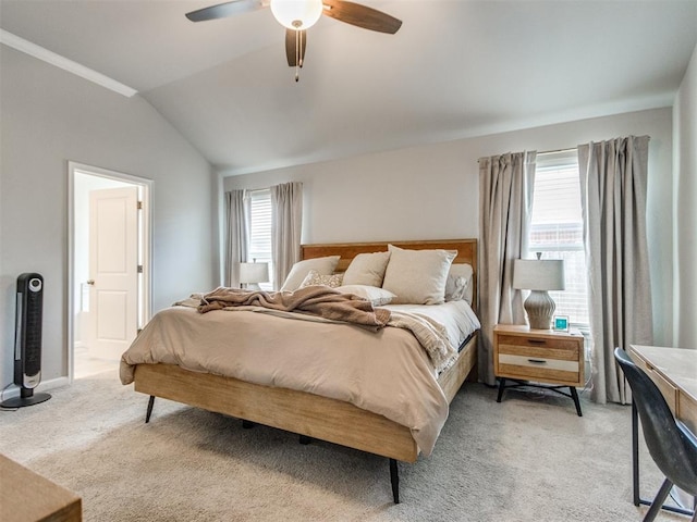 bedroom with multiple windows, light carpet, lofted ceiling, and a ceiling fan