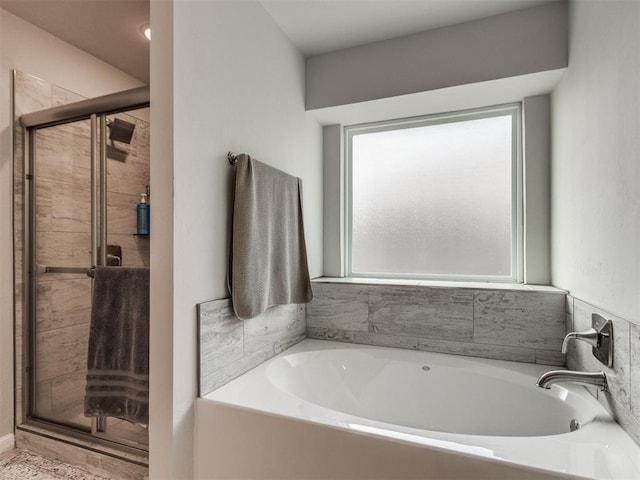 full bath featuring a stall shower and a garden tub