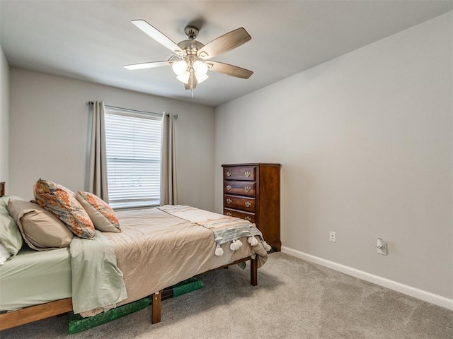 carpeted bedroom with baseboards and ceiling fan