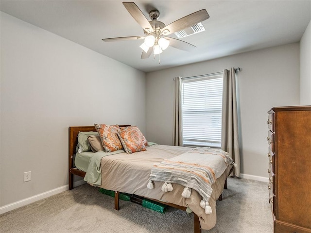 bedroom with baseboards, carpet floors, visible vents, and ceiling fan