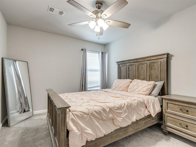 bedroom featuring ceiling fan, light colored carpet, visible vents, and baseboards