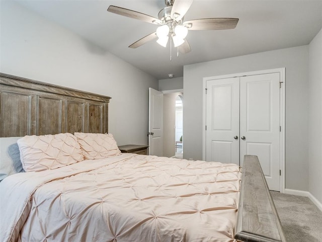 carpeted bedroom with a closet, ceiling fan, and baseboards