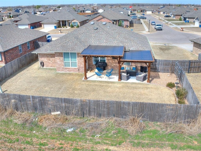 back of house with a patio area, a residential view, an outdoor hangout area, and a fenced backyard