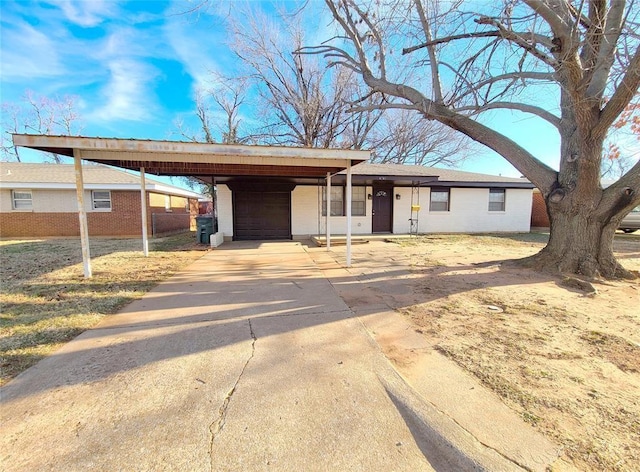 ranch-style house featuring an attached garage and driveway