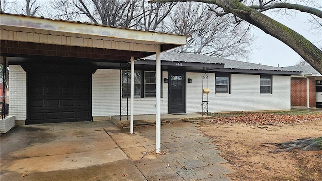 exterior space featuring an attached carport and brick siding