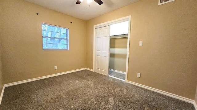 unfurnished bedroom featuring a closet, visible vents, baseboards, and carpet