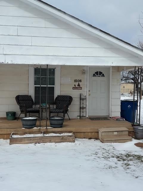 view of snow covered property entrance