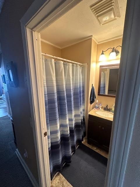 bathroom with visible vents, vanity, a shower with shower curtain, and ornamental molding