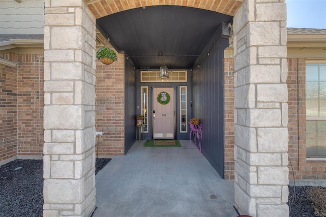 property entrance featuring brick siding