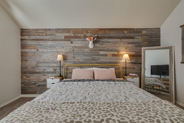 unfurnished bedroom featuring wooden walls, carpet flooring, and baseboards