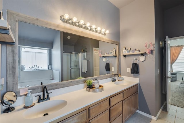 bathroom with tile patterned floors, a stall shower, a bath, and a sink