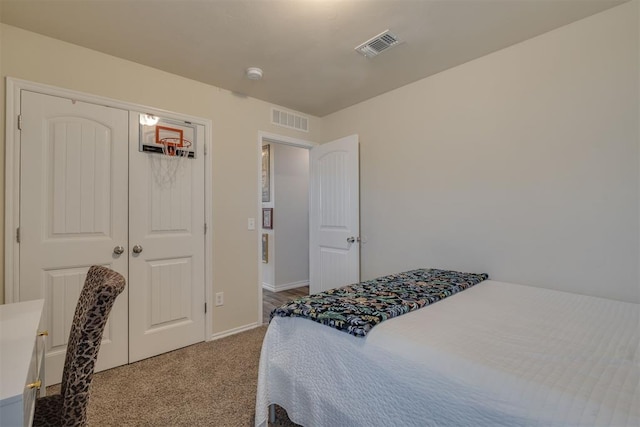 bedroom with visible vents, baseboards, a closet, and carpet flooring