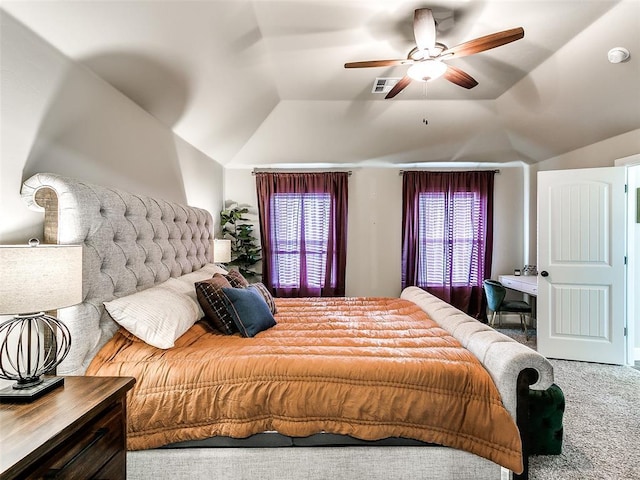 carpeted bedroom with visible vents, lofted ceiling, and ceiling fan