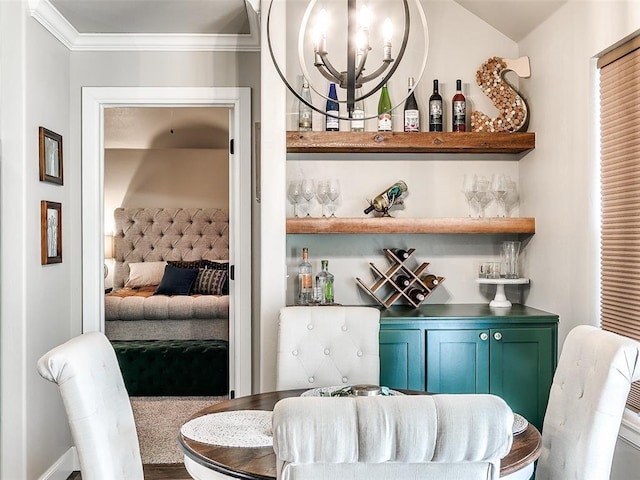 dining space with a chandelier, a dry bar, and crown molding