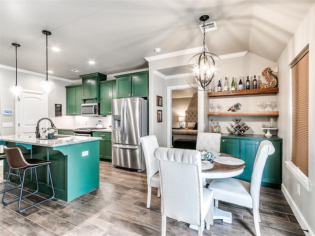 kitchen with visible vents, green cabinets, appliances with stainless steel finishes, an inviting chandelier, and a sink