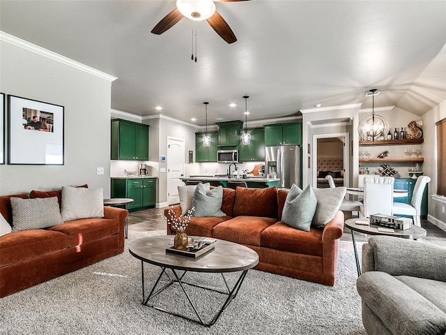 living room featuring baseboards, ornamental molding, recessed lighting, ceiling fan with notable chandelier, and wood finished floors