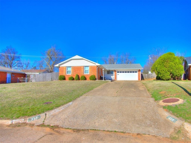 ranch-style home featuring concrete driveway, an attached garage, fence, and a front lawn