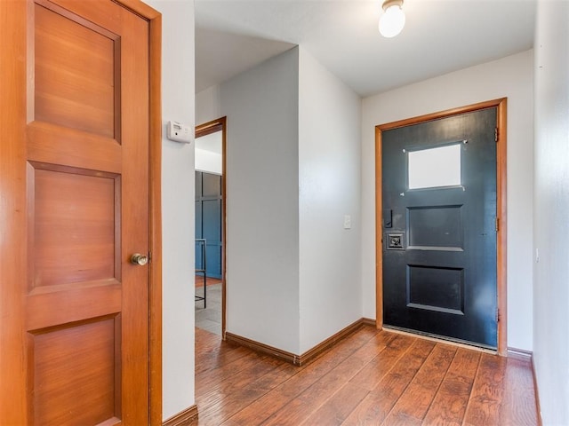 entryway with baseboards and dark wood-style flooring