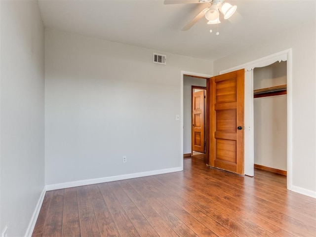 unfurnished bedroom with visible vents, baseboards, and hardwood / wood-style flooring