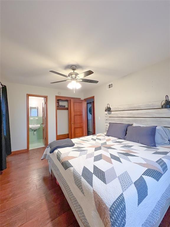 bedroom with visible vents, a ceiling fan, wood finished floors, connected bathroom, and baseboards