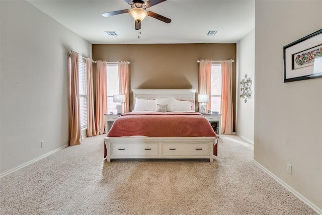 bedroom with visible vents, multiple windows, and baseboards