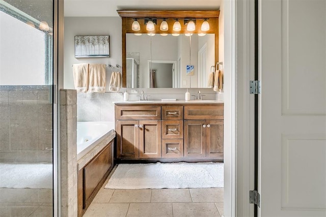 bathroom with a sink, a shower stall, a bath, and double vanity