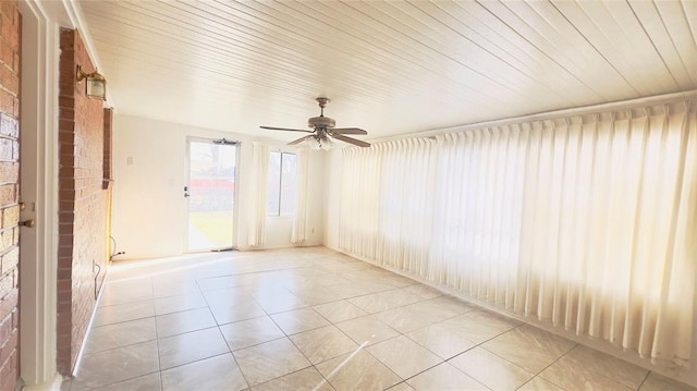 3731 Newport St, Oklahoma City, OK 73112 - unfurnished room featuring light tile patterned flooring, wooden ceiling, brick wall, and a ceiling fan