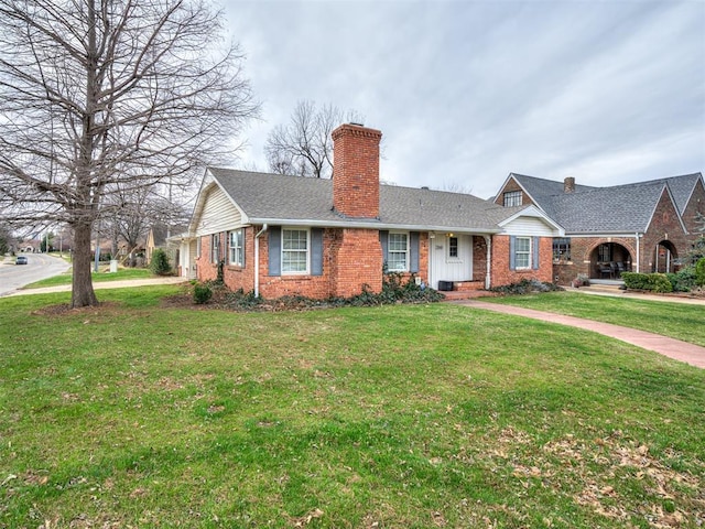 view of front facade featuring a front lawn, brick siding, and a chimney