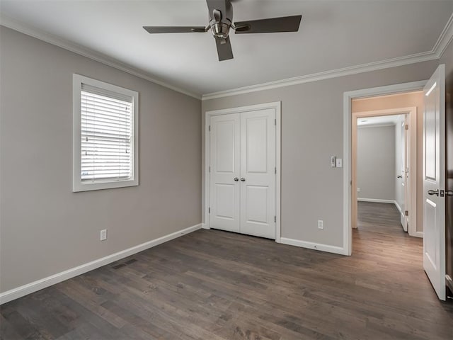 unfurnished bedroom featuring crown molding, dark wood-style floors, visible vents, and baseboards