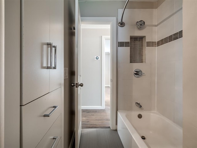 bathroom with wood finished floors and shower / bathtub combination