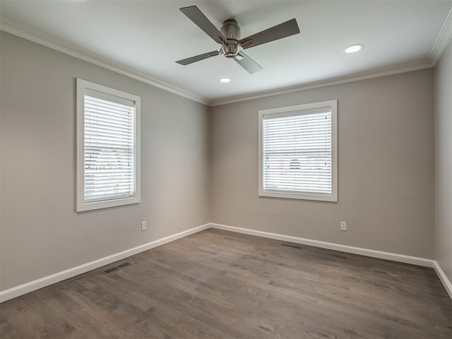 empty room featuring visible vents, ceiling fan, baseboards, ornamental molding, and dark wood-style floors