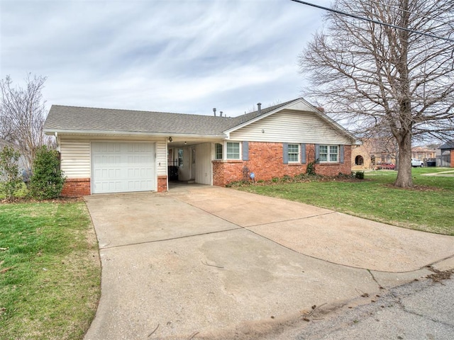 single story home featuring an attached carport, a front yard, brick siding, and driveway