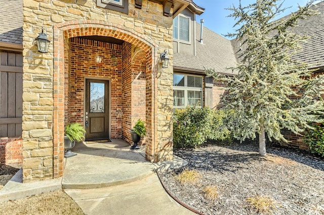 2241 W Mickey Dr, Mustang, OK 73064 - entrance to property with brick siding, roof with shingles, and stone siding