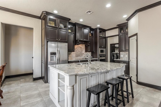 2241 W Mickey Dr, Mustang, OK 73064 - kitchen featuring baseboards, crown molding, stainless steel appliances, and a sink