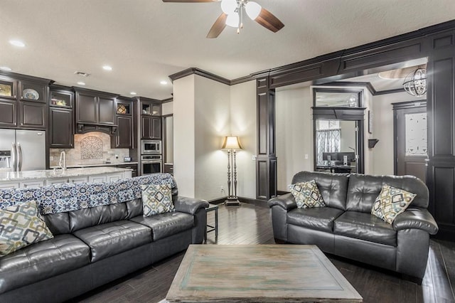 2241 W Mickey Dr, Mustang, OK 73064 - living room with recessed lighting, dark wood finished floors, a ceiling fan, ornamental molding, and baseboards