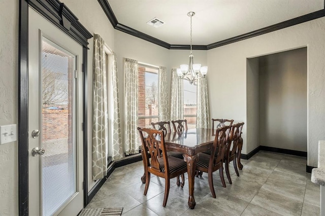 2241 W Mickey Dr, Mustang, OK 73064 - dining room with baseboards, visible vents, an inviting chandelier, and crown molding
